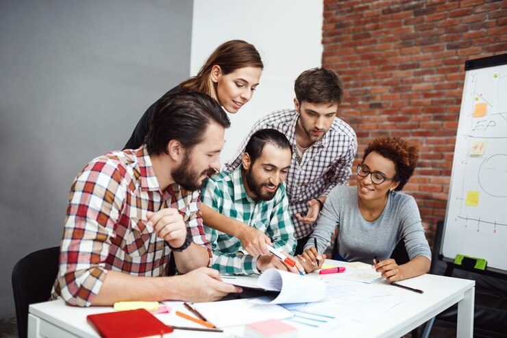 Digital marketing team working in an office, creating a strategy for a company requesting a Florida outsourcing wage solution.