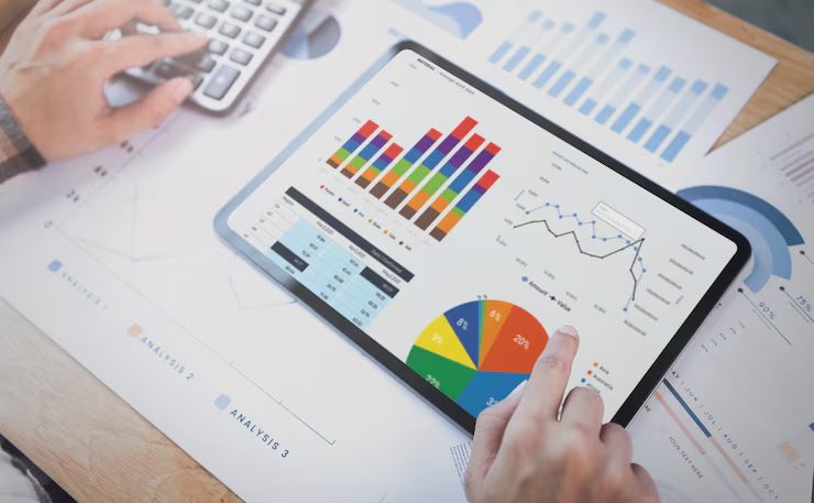A person’s hand pointing to a tablet displays detailed information related to the results of a Quarterly Strategy for optimization.