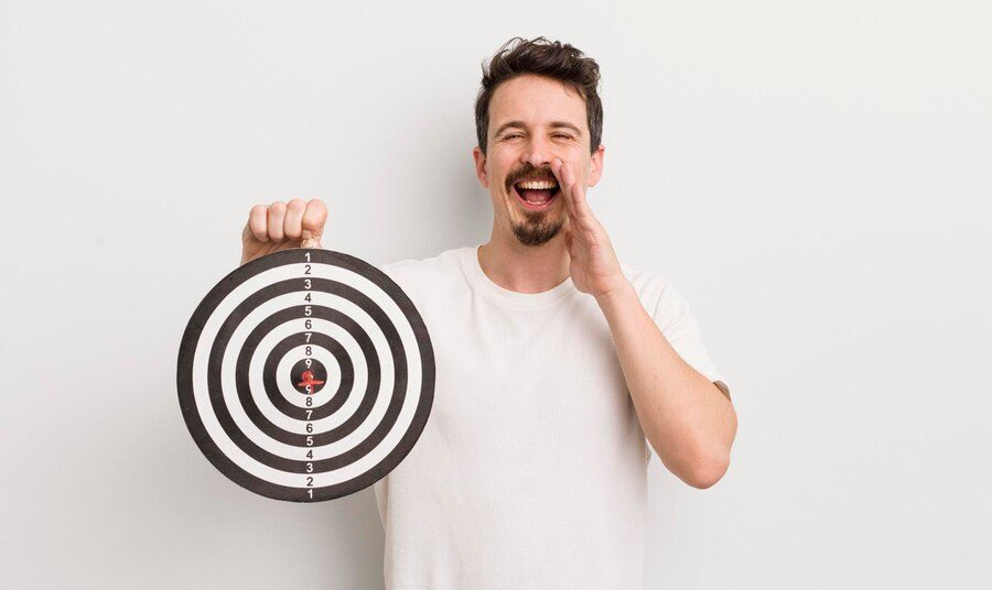 White background with a man holding a target, representing effective audience targeting for PPC campaigns.