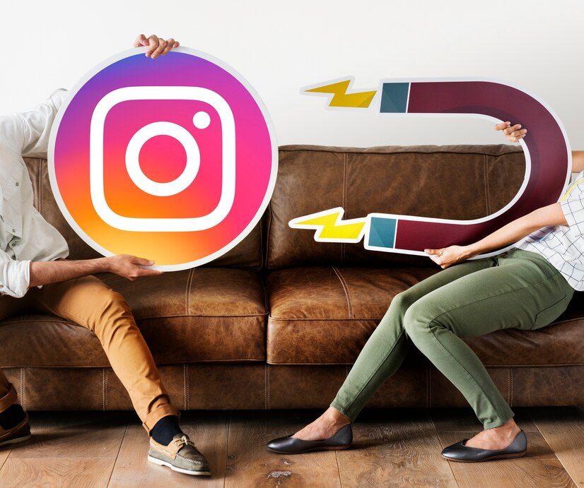 One person holding an Instagram logo while another person holds a magnet, representing how to leverage the new Instagram music feature for increased engagement.