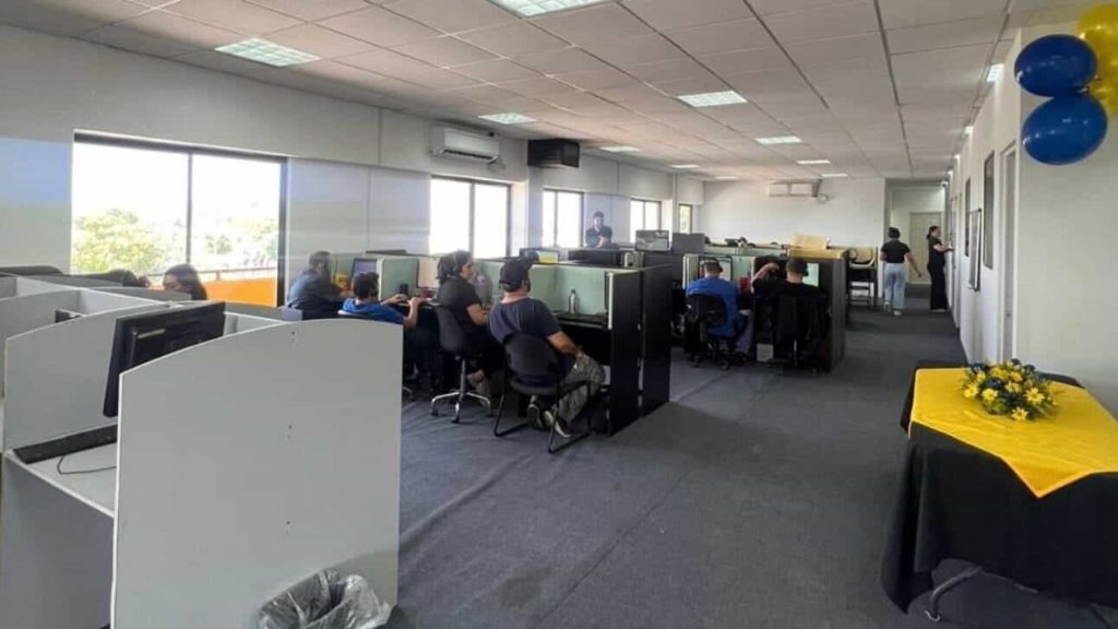 A well-equipped contact center in Nicaragua with team members working at individual desks, representing outsourcing efficiency.