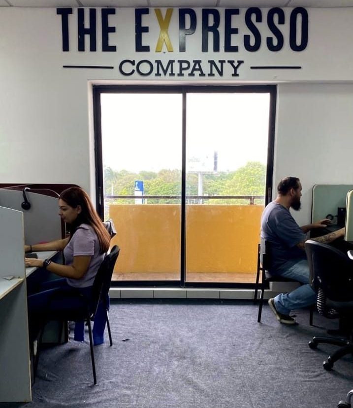 Expresso Company employees working in individual workstations, showcasing a professional outsourcing office in Nicaragua
