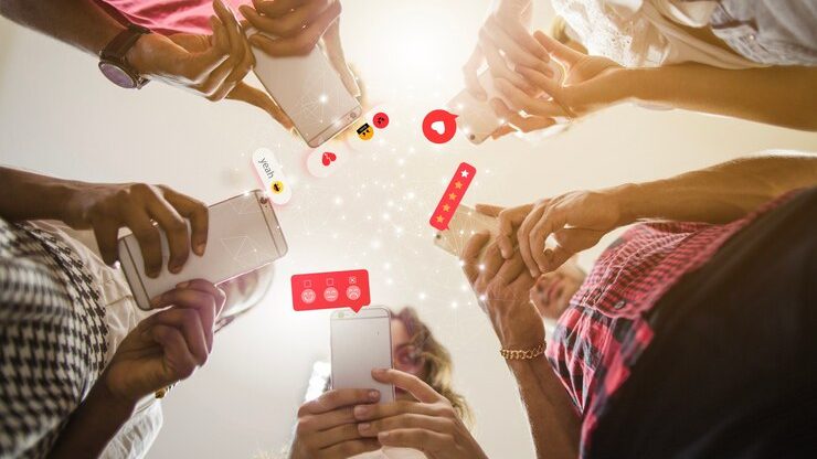 A group of people using smartphones with social media icons, showcasing the rising marketing trend for 2025 in social media engagement.