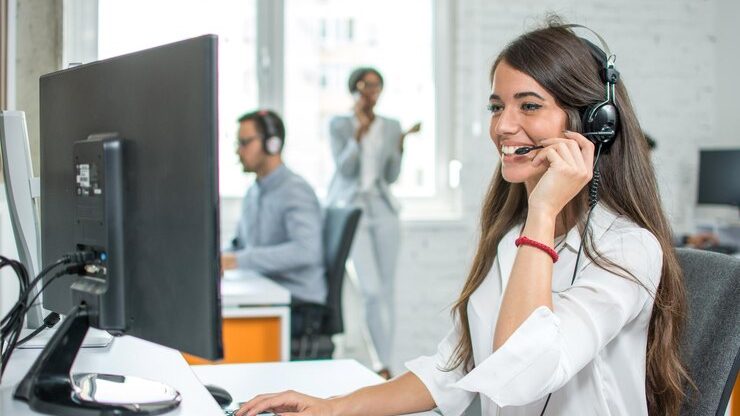 Contact center agent wearing a headset, enhancing customer service at a workstation