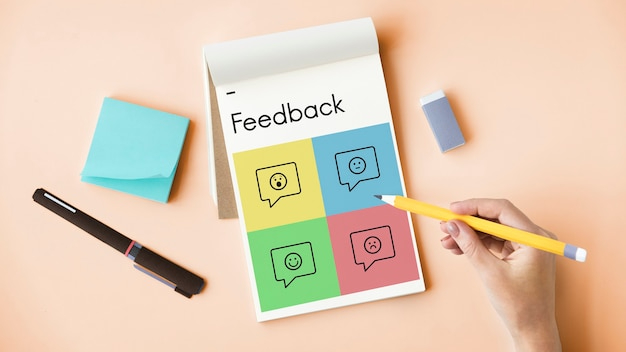 Handwriting feedback on a colorful survey form with different sentiment icons to evaluate customer satisfaction.