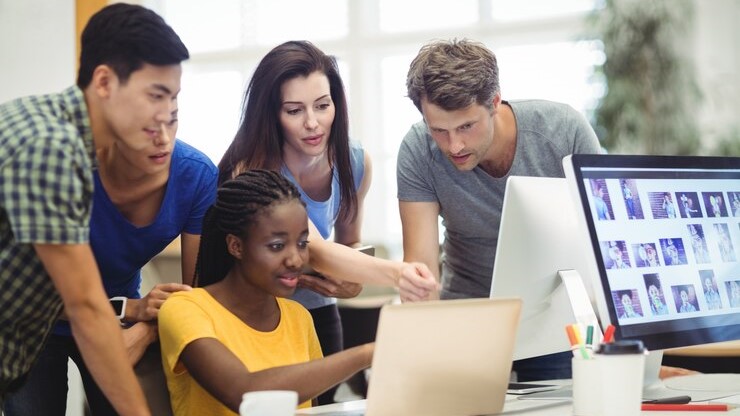 A team of professionals working collaboratively on social media strategies to adapt to the TikTok ban.