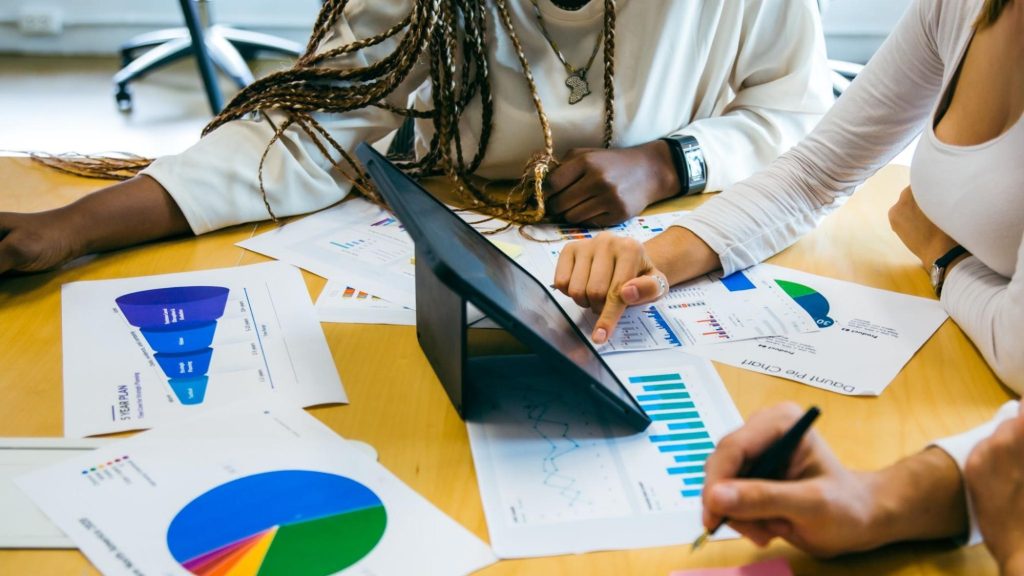A marketing team analyzing data-driven marketing reports, discussing customer insights and predictive analytics for campaign optimization.