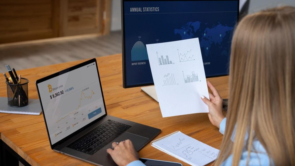 A business professional reviewing a marketing analytics dashboard on a laptop, analyzing key performance metrics and digital marketing optimization trends.
