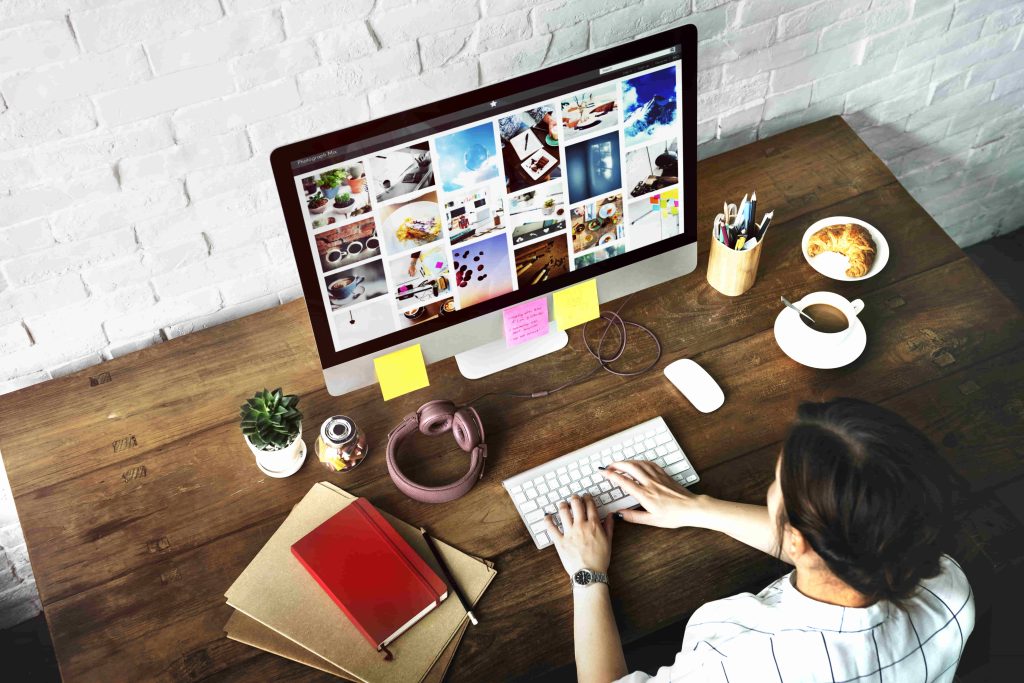 Marketer designing visual content on desktop for AI search optimization