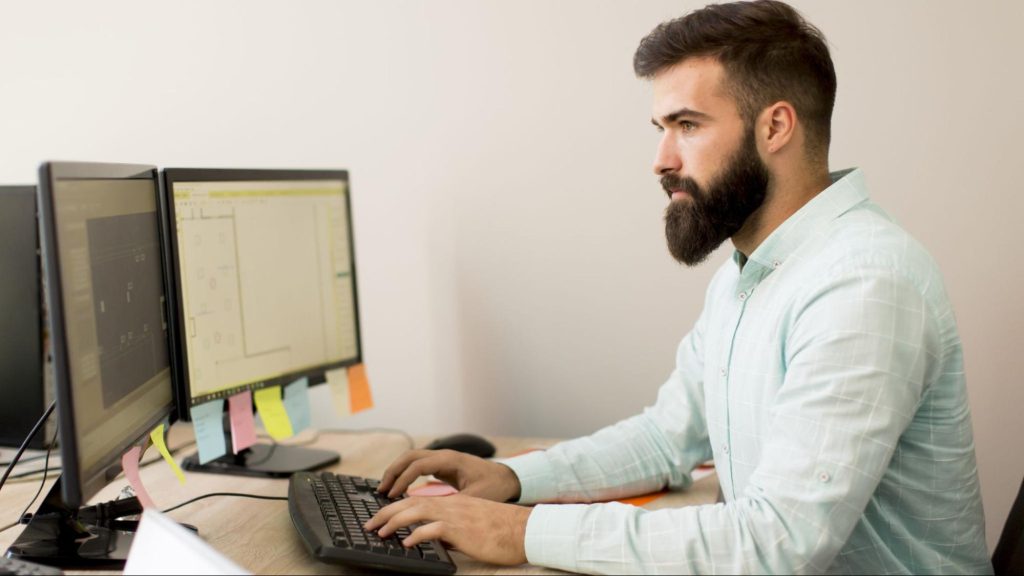 Man working on content layout and SEO workflow, illustrating how digital creators boost search performance.