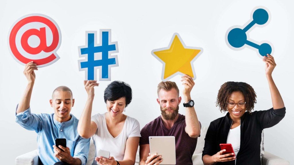 Diverse group of people holding social media icons representing engagement and content reach.