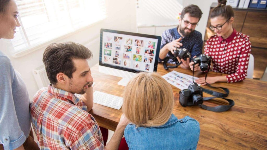 Team planning growth hacks for content marketing using digital visuals and strategy tools.