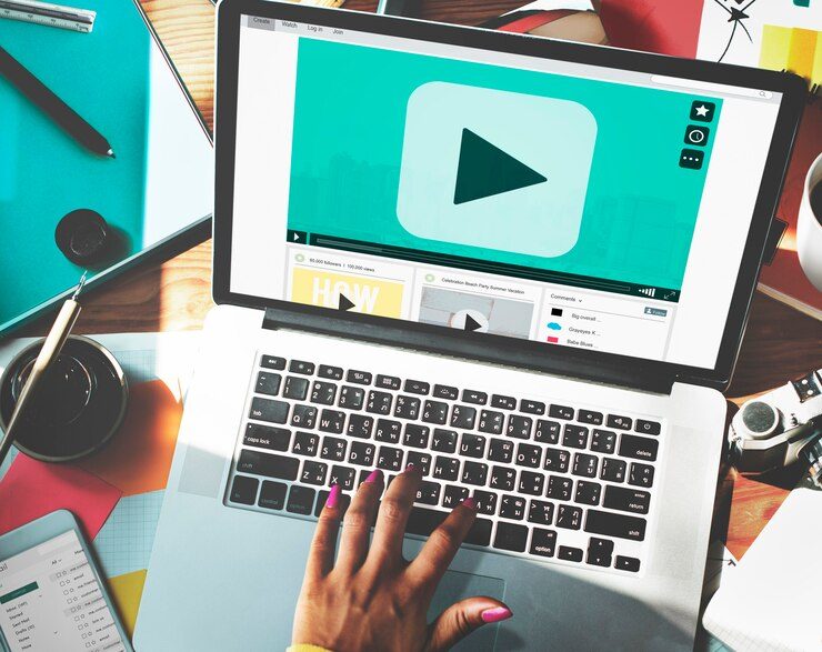 Woman's Hand Using Laptop to Play YouTube Video with Blue Turquoise Screen