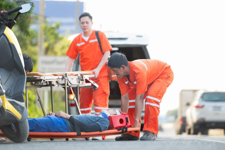 Paramedics assisting an injured passenger after a car accident.