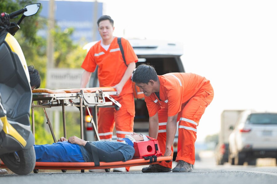 Paramedics assisting an injured passenger after a car accident.